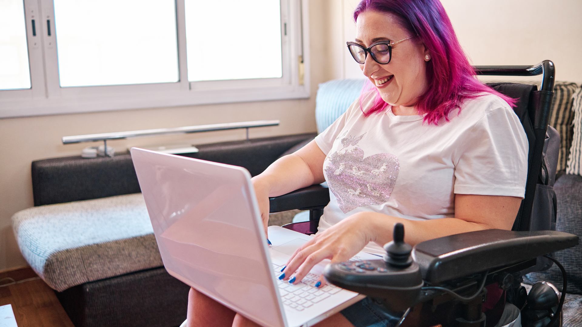 a woman working on a computer in a wheelchair